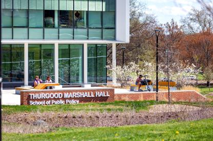 Modern glass campus building with a brick sign reading "Thurgood Marshall Hall."